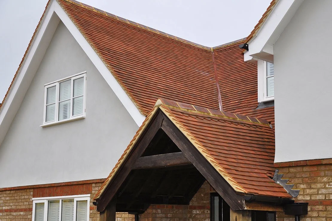 New clay tiled roof with gable ends and an oak porch