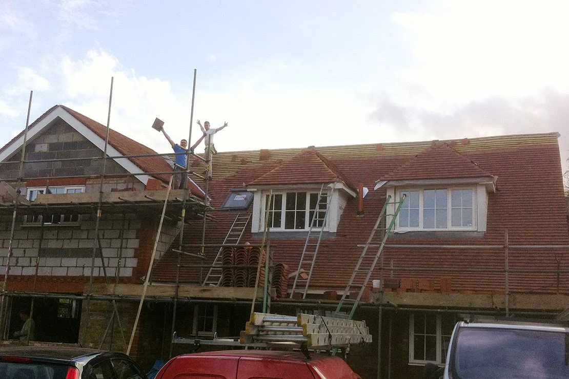 C.A. Bond & Sons roofers working on a scaffolded re-roof